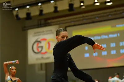 Dancesport competitor: Male dancer: black long-sleeved top with subtle sequin details and black pants