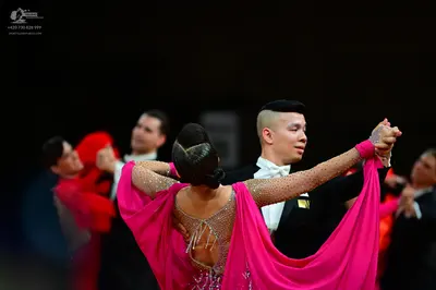 Dancesport competitor: Female dancer: pink latin dress with rhinestones on a nude mesh back and long, f