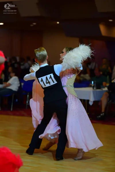 Dancesport competitor #141: Male dancer: black vest over a white long-sleeved shirt and black trousers