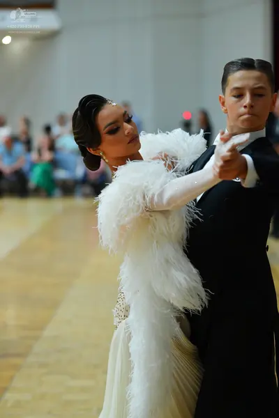 Dancesport competitor: Male dancer: black suit with a white shirt