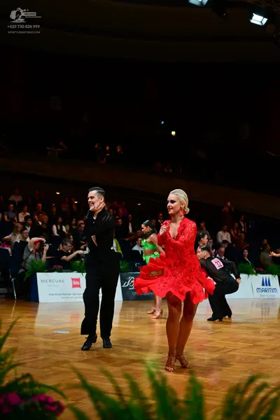 Dancesport competitor: Male dancer: black long-sleeved shirt and black trousers
