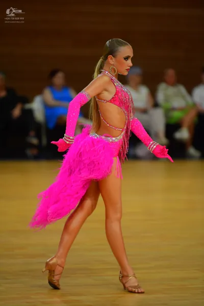 Dancesport competitor: ** Bright Pink Latin Dress
*   **Fabric:** Appears to be a satin base with heavy