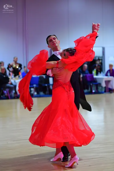 Dancesport competitor: Male dancer: black formal suit with a white shirt and white bow tie