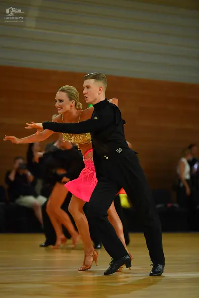 Dancesport competitor: Male dancer: black long-sleeved shirt and black trousers