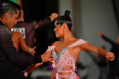 Dancesport competitor #04: Male dancer (foreground): black long-sleeved top with sequins
