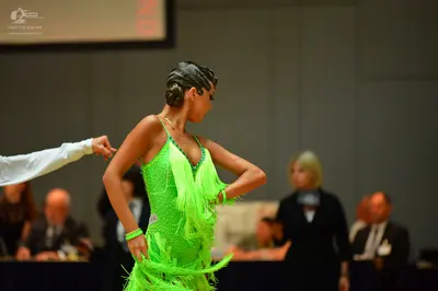Dancesport competitor: Female dancer: neon green Latin dress with fringe and sequins