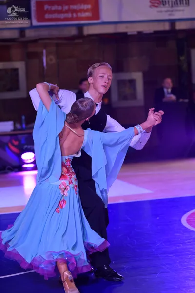 Dancesport competitor: Male dancer: white long-sleeved shirt, black waistcoat, and black trousers