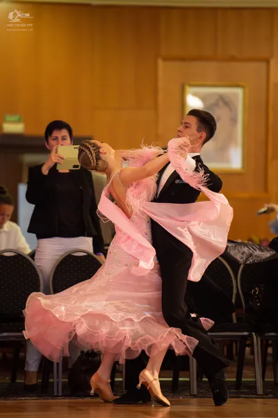Dancesport competitor: Male dancer: black suit with a white shirt and black bow tie