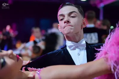 Dancesport competitor: Male dancer: black suit with white shirt and white bowtie