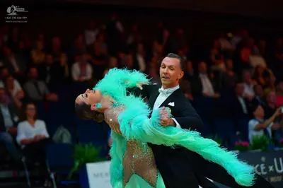Dancesport competitor: Male dancer: black suit with a white shirt and white bowtie