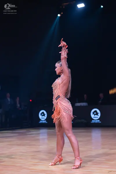 Dancesport competitor: Female dancer: champagne-colored latin dance dress with heavy sequin embellishme