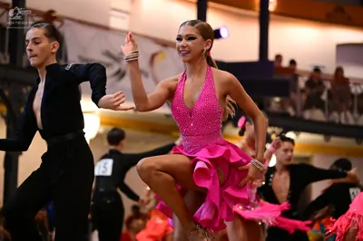 Dancesport competitor #13: Male dancer (foreground): black long-sleeved shirt and black trousers