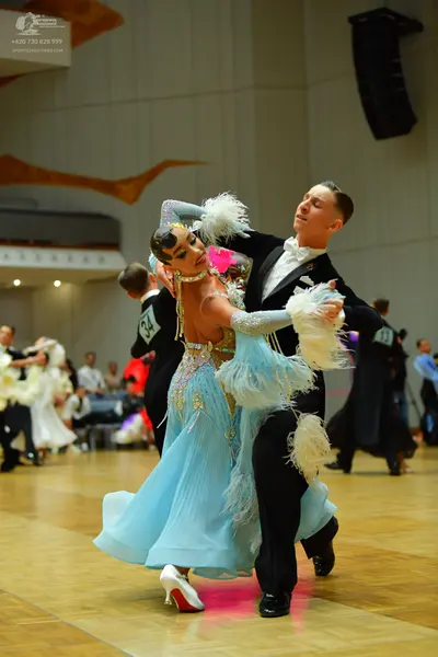 Dancesport competitor: Male dancer: black suit with white shirt