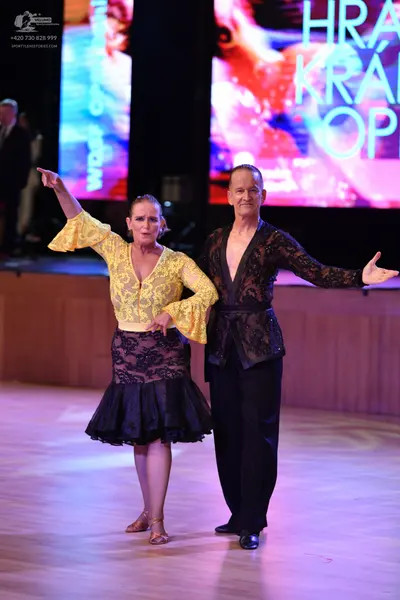 Dancesport competitor: ** Black suit with a wide, sequined lapel