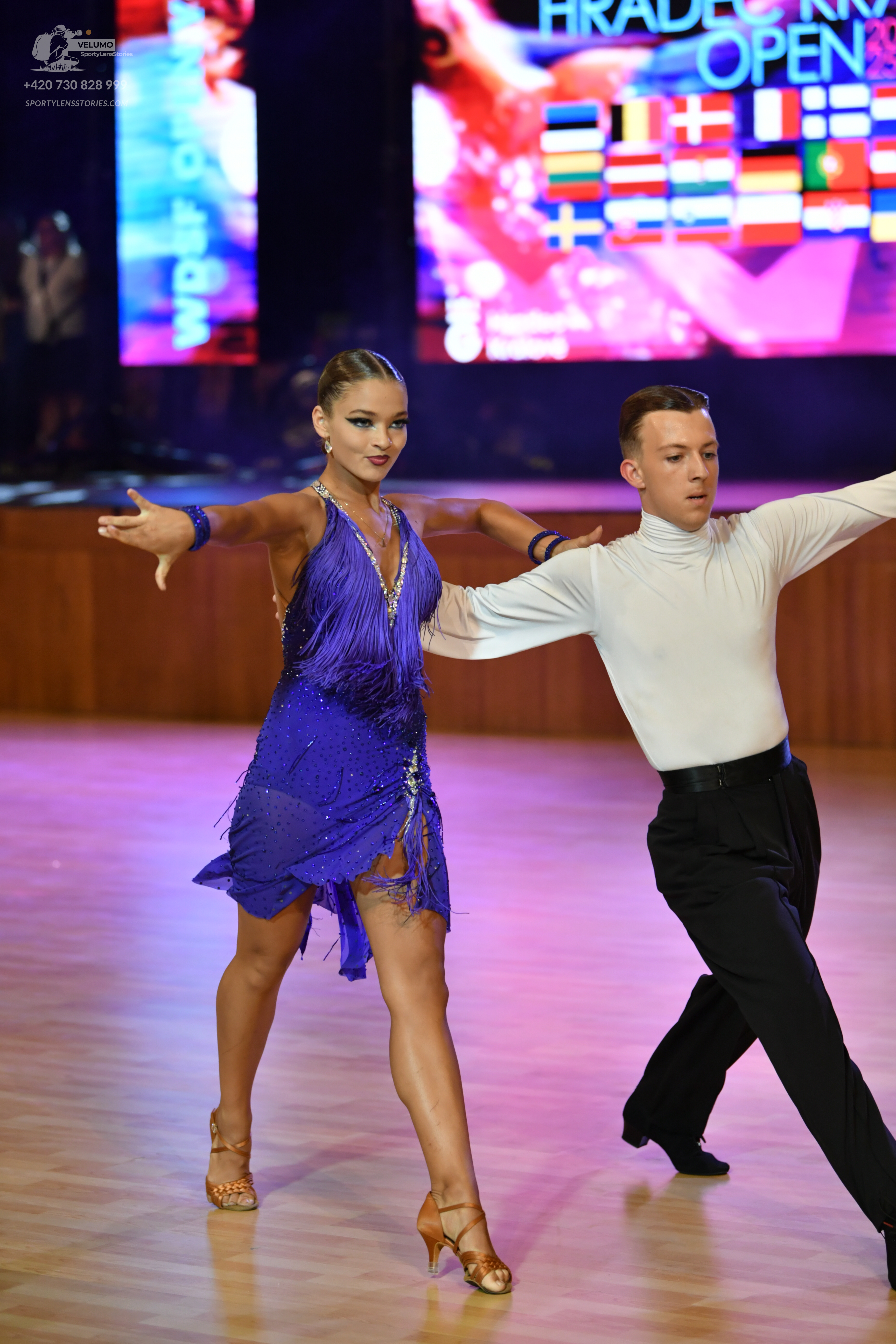 Dancesport competitor: ** Black, satin ballroom suit