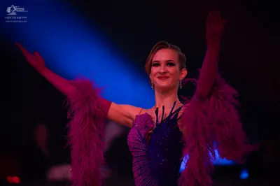 Dancesport competitor: Female dancer: dark purple/magenta latin dress with sequins on the bodice and la