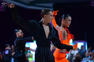 Dancesport competitor: Male dancer: black long-sleeved shirt and black trousers