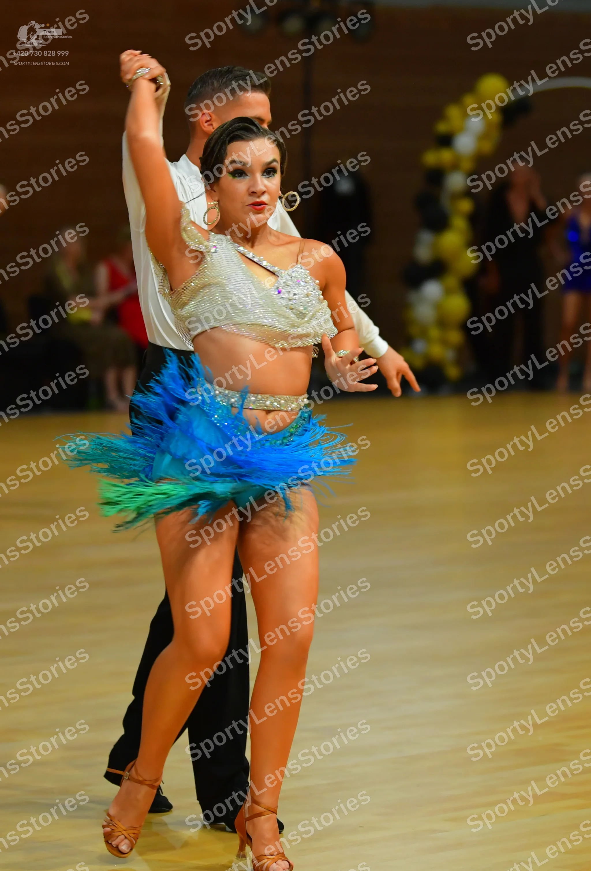 Dancesport competitor: ** Red Latin dress
*   **Fabric:** Appears to be satin with a fringe detail