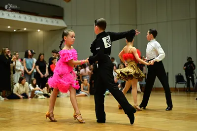 Dancesport competitor #58: Female dancer in foreground: bright pink ruffled latin dress
