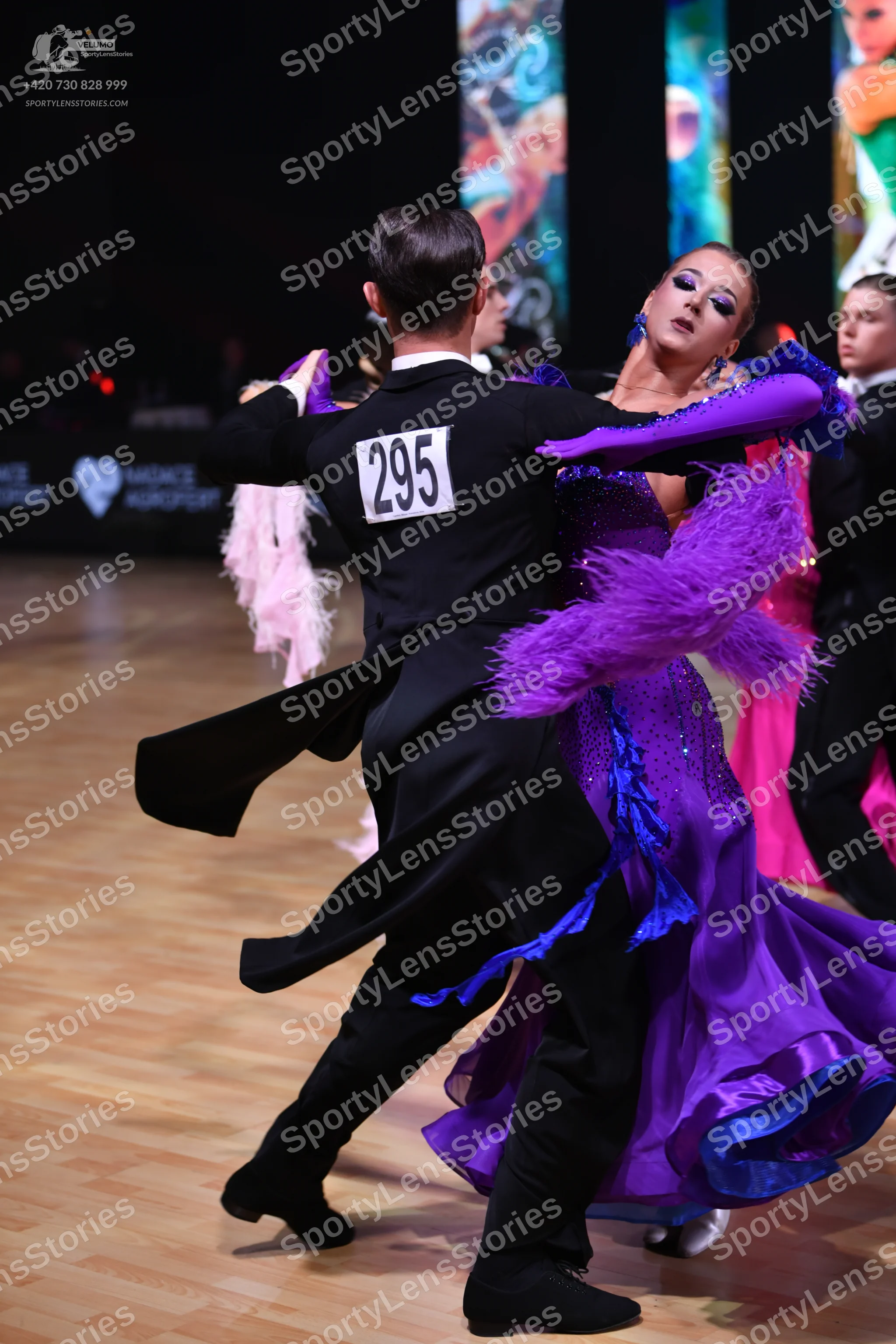 Dancesport competitor: Male dancer (foreground): black ballroom tailcoat, white shirt, and black trouse