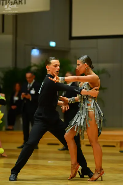 Dancesport competitor: Male dancer: black long-sleeved shirt and black trousers