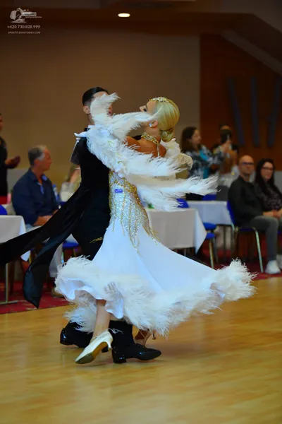 Dancesport competitor: Male dancer: black dance suit with a long, flowing black fabric element