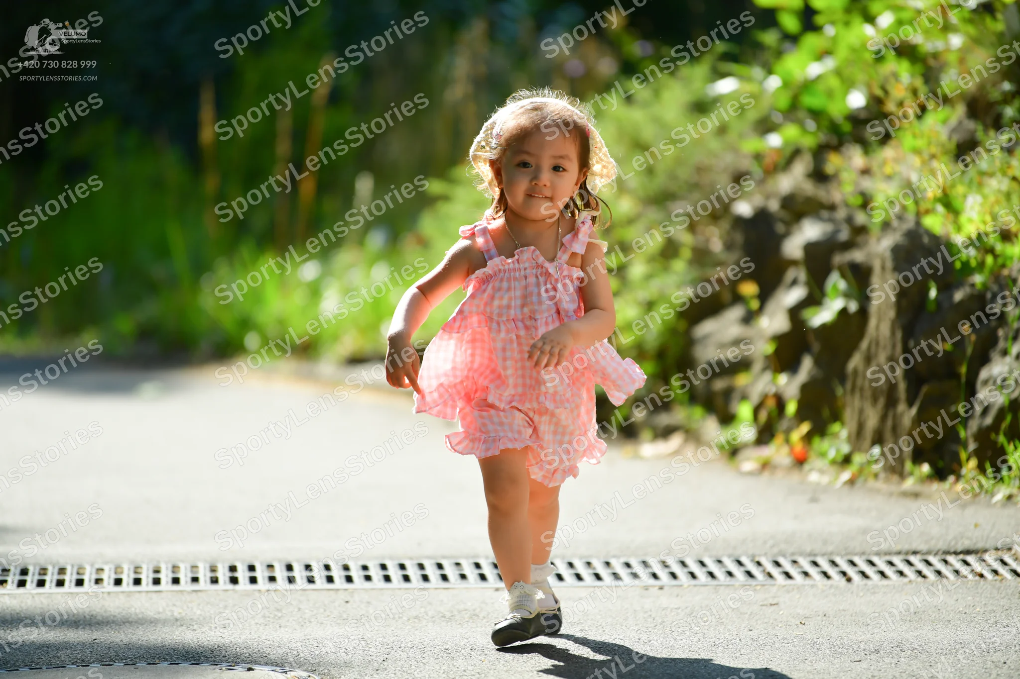 Dancesport competitor: Child: pink patterned sleeveless dress