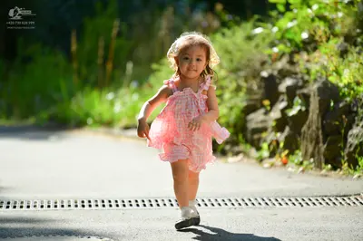Dancesport competitor: Child: pink patterned sleeveless dress
