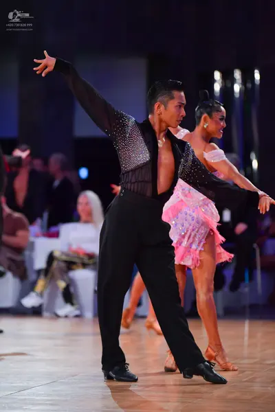 Dancesport competitor: Male dancer: black long-sleeved shirt with a sheer mesh panel on the chest and s