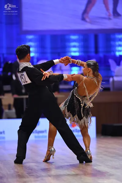 Dancesport competitor: Male dancer: black suit with white/silver satin lapels and black trousers