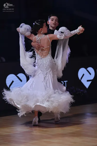 Dancesport competitor: Female dancer: white ballgown with intricate crystal and bead embellishments on 