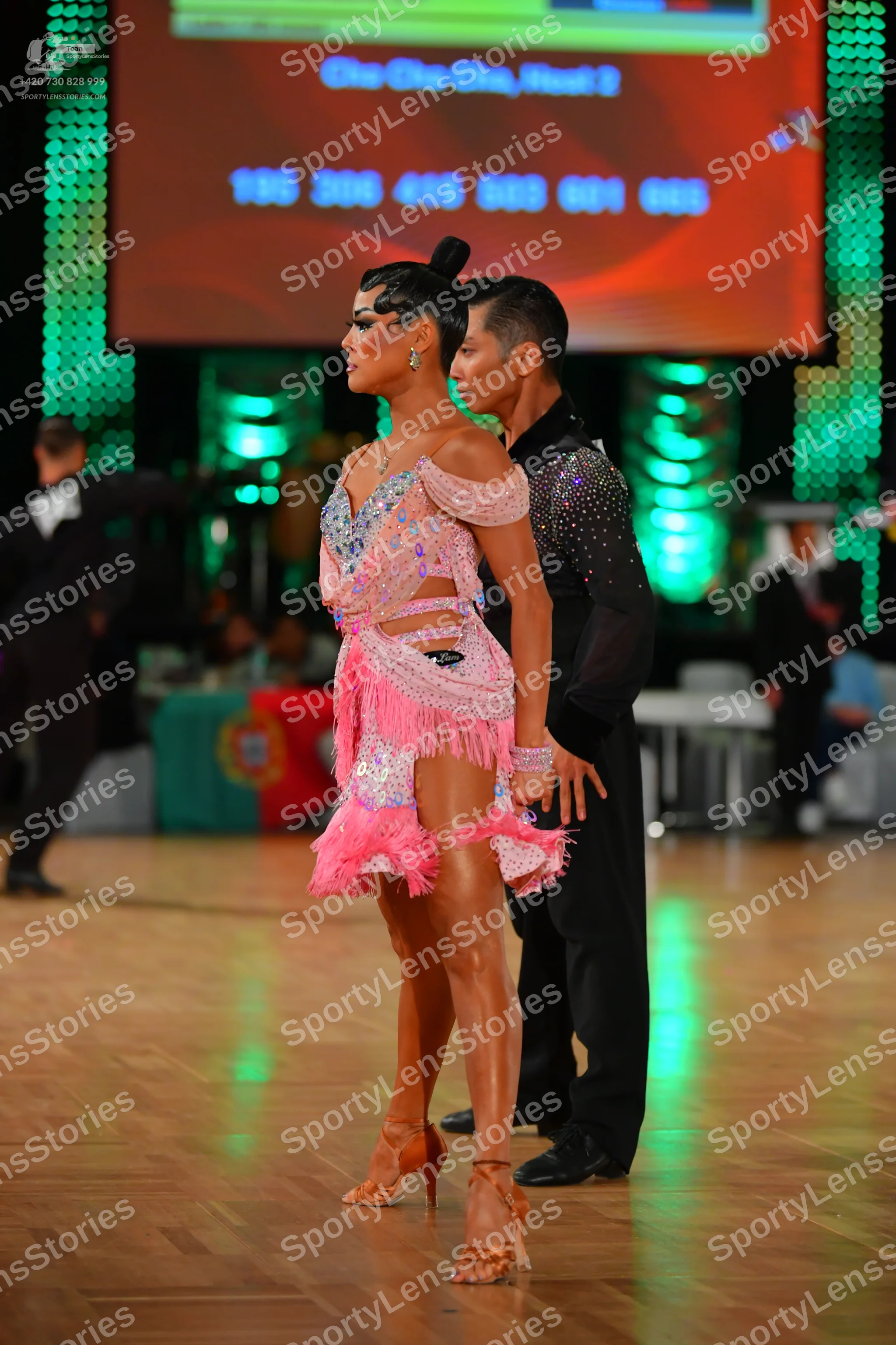 Dancesport competitor: Female dancer: pink latin dress with sequins, rhinestones, and fringe