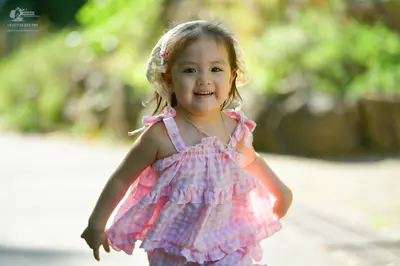 Dancesport competitor: Female dancer: pink and white checkered ruffled top with a white lace headband
