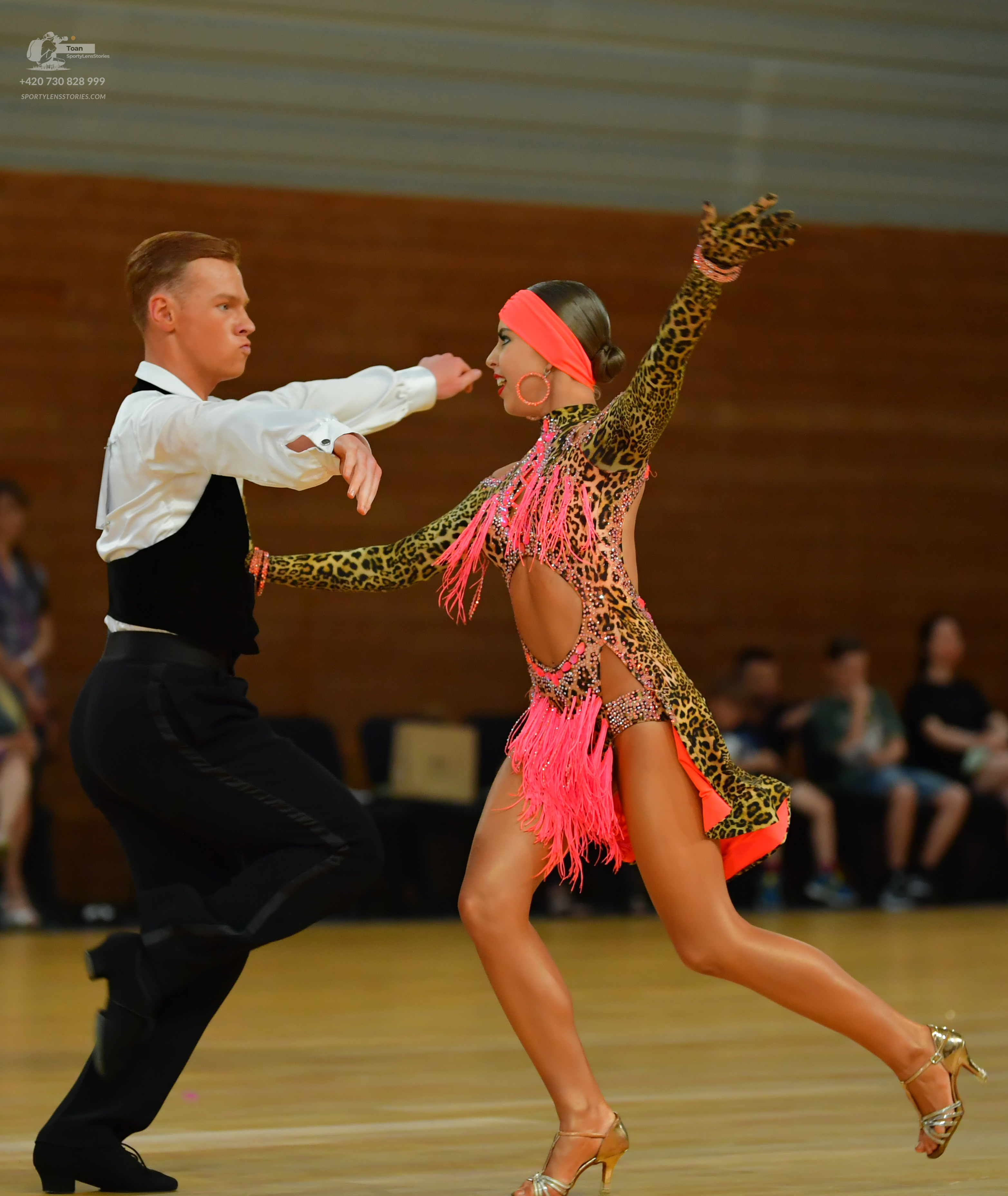 Dancesport competitor: Male:** Black tailored suit with sequin lapels