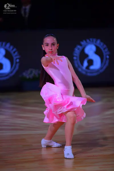 Dancesport competitor: Female dancer: pink latin dress with a ruffled skirt