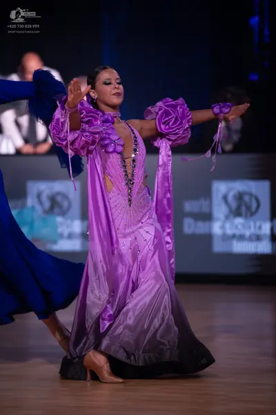 Dancesport competitor: Female dancer: purple and black ombre satin ballroom gown with large fabric rose