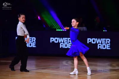 Dancesport competitor: Male dancer: white long-sleeved shirt and black trousers