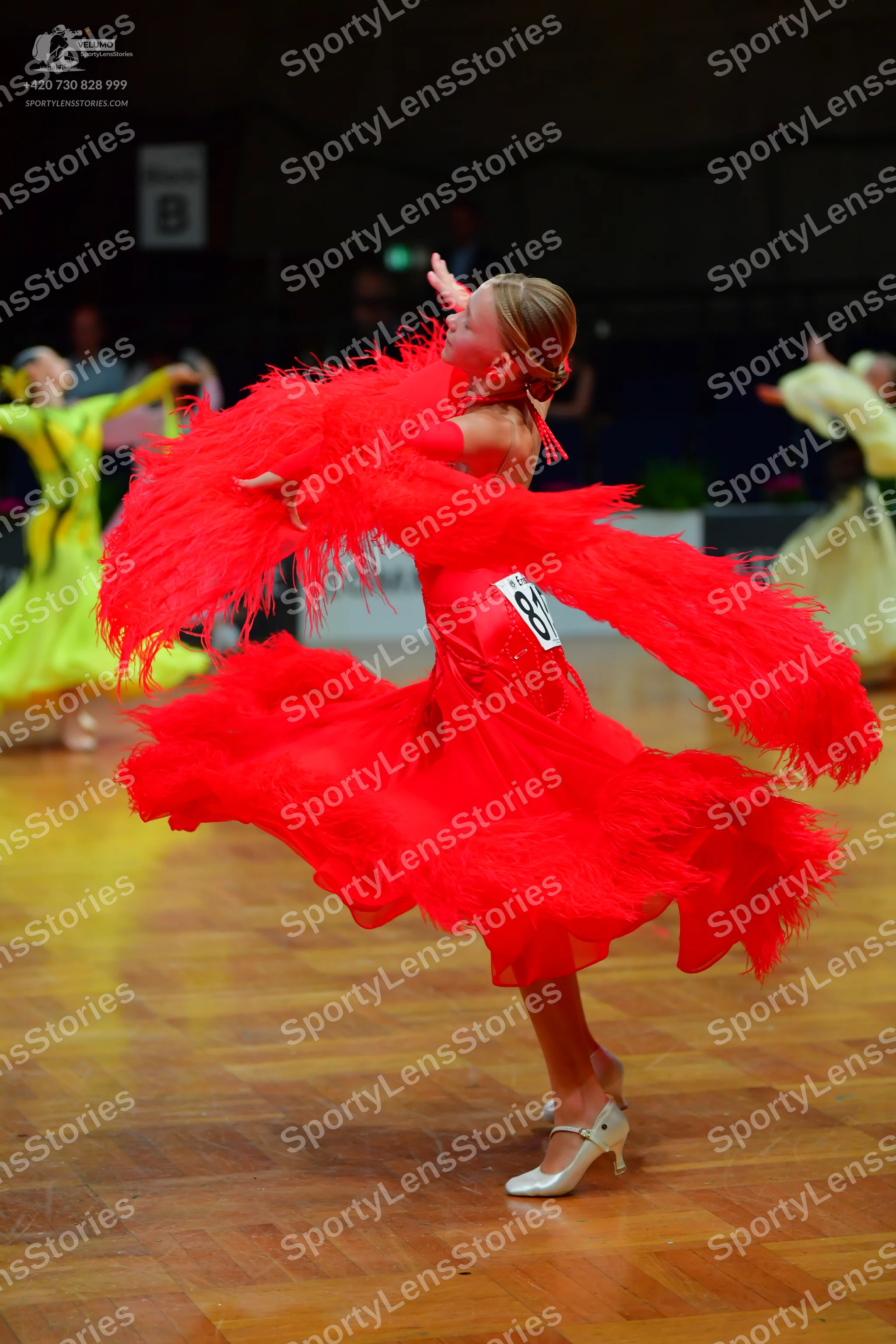 Dancesport competitor #81: Female dancer in foreground: red latin dress with long fringe