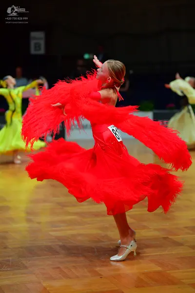 Dancesport competitor #81: Female dancer in foreground: red latin dress with long fringe