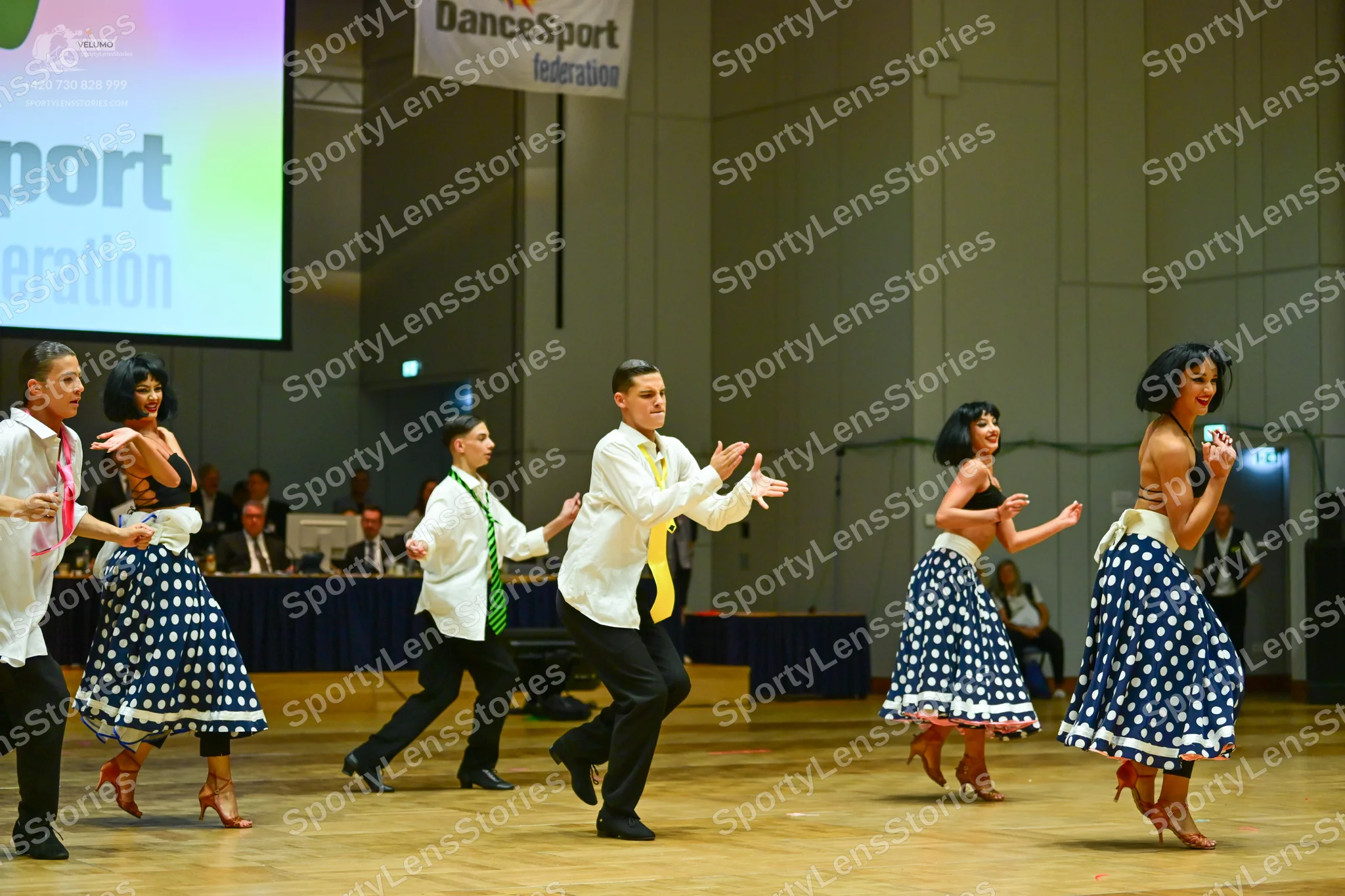 Dancesport competitor: Male dancers: white shirts (some short-sleeved, some long-sleeved) with pink, gr
