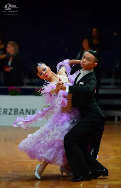 Dancesport competitor: Male dancer: black suit with a white shirt and black bow tie