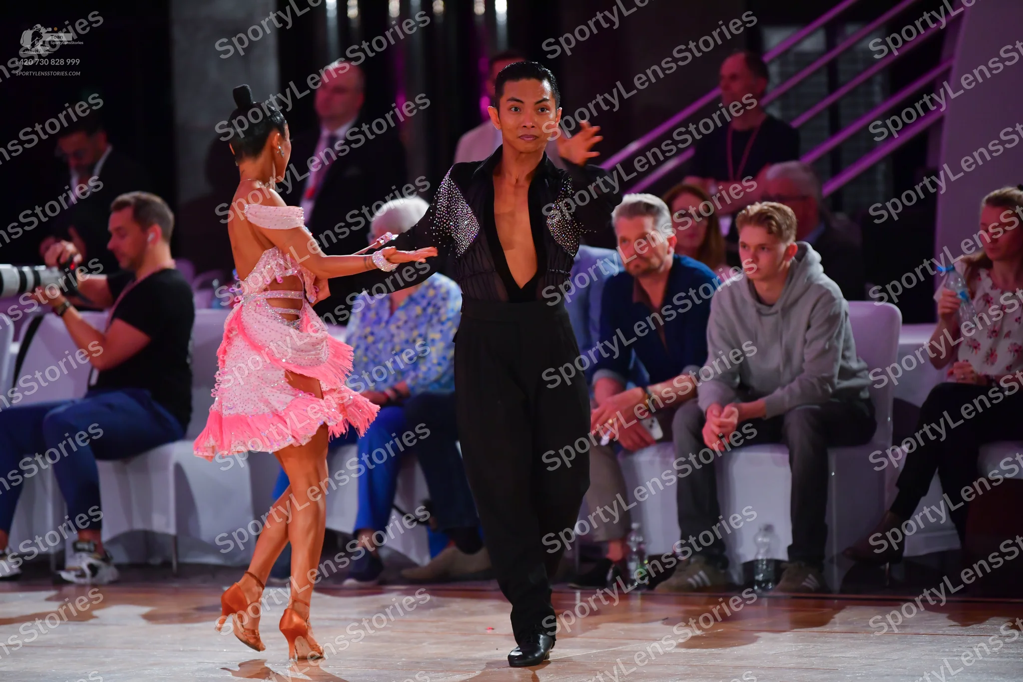 Dancesport competitor: Female dancer: light pink Latin dress with a ruffled, layered skirt