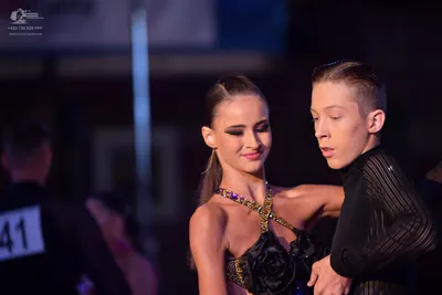 Dancesport competitor #41: Female dancer: black Latin dance dress with gold/metallic sequin embellishments 