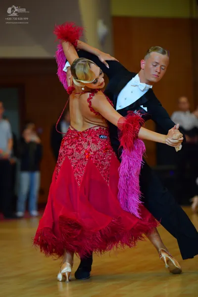 Dancesport competitor: Male dancer: black suit with a white shirt and white bowtie