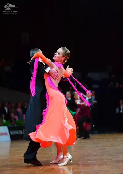 Dancesport competitor: Male dancer: black tailcoat suit with a white shirt and visible cuffs