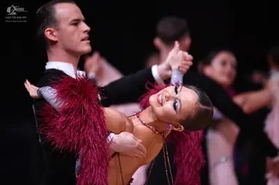 Dancesport competitor: Male dancer: black suit with a white shirt