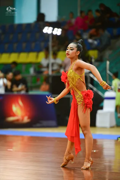 Dancesport competitor: ** Red Latin Dress
*   **Color:** Predominantly vibrant red