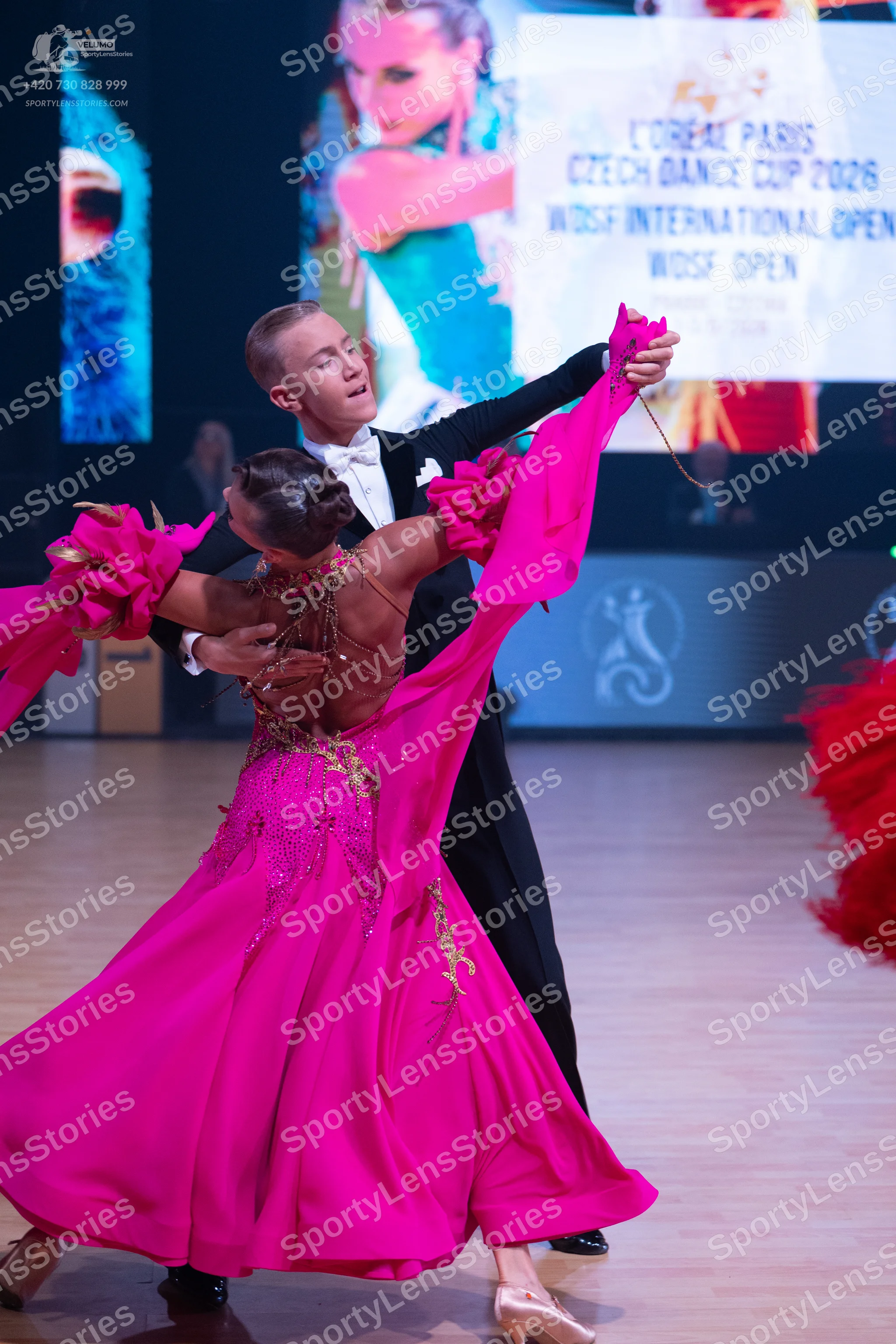 Dancesport competitor: Male dancer: black suit with a white shirt and white bowtie