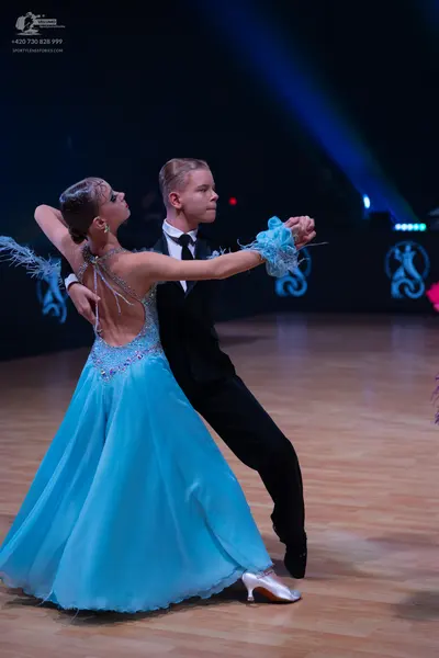 Dancesport competitor: Male dancer: black suit with a white shirt and black tie