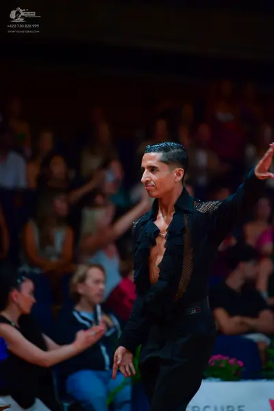 Dancesport competitor: Male dancer: black latin dance shirt with sheer mesh panels and ruffled front, p